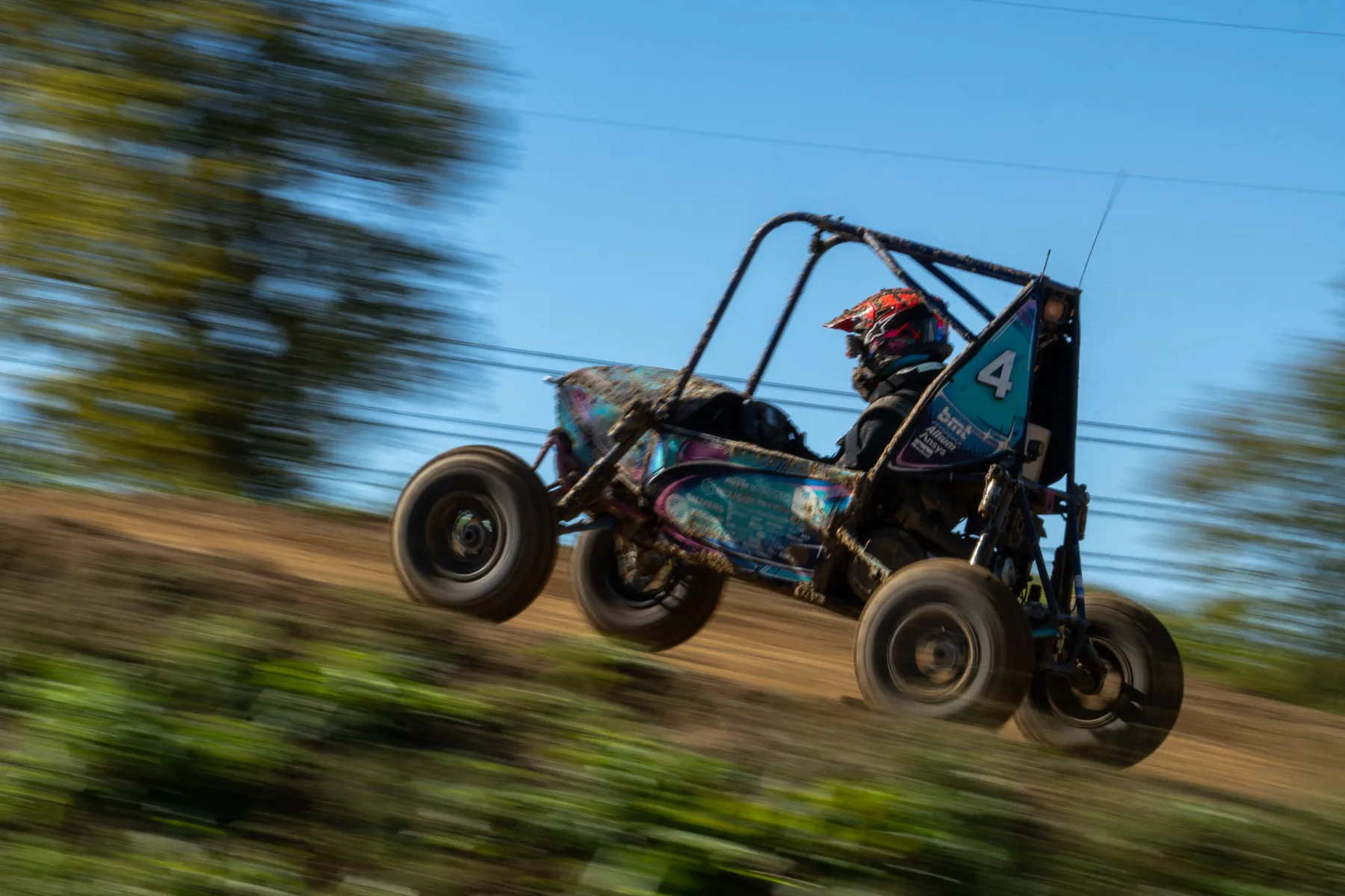 CWRU Motorsports SR26 at speed on a dirt track